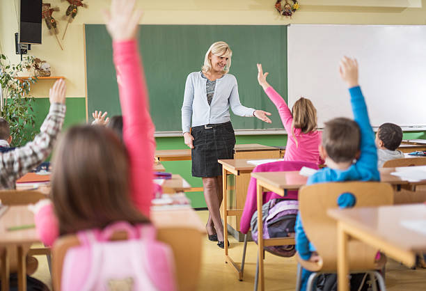 istock Teacher calling over one of students to answer the question. 471218268