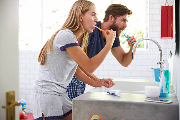 istock Couple In Pajamas Brushing Teeth In Bathroom 471219154