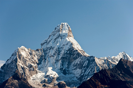 Ama Dablam is a mountain in the Himalaya range of eastern Nepal. The main peak is 6,812  metres (22,349 ft), the lower western peak is 5,563 metres (18,251 ft). Ama Dablam means  