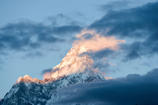 Ama Dablam is a mountain in the Himalaya range of eastern Nepal. The main peak is 6,812  metres (22,349 ft), the lower western peak is 5,563 metres (18,251 ft). Ama Dablam means  