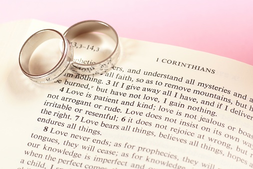 Two rings on open Bible - 1. Corinthians chapter 13.