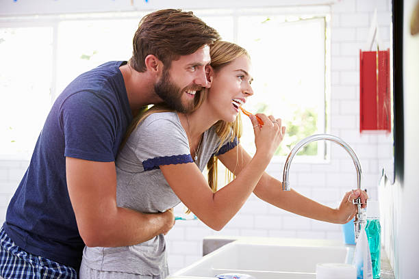istock Couple In Pajamas Brushing Teeth In Bathroom 471221218