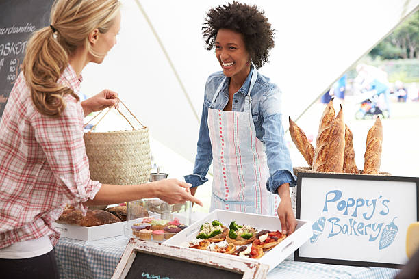istock A female bakery stall holder serving customers at the market 471221490