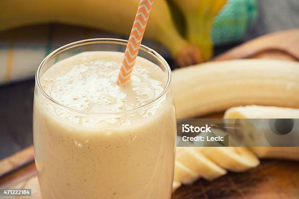 Freshmade Glass Of Banana Smoothie With Straw On Wood Stock Photo - Download Image Now