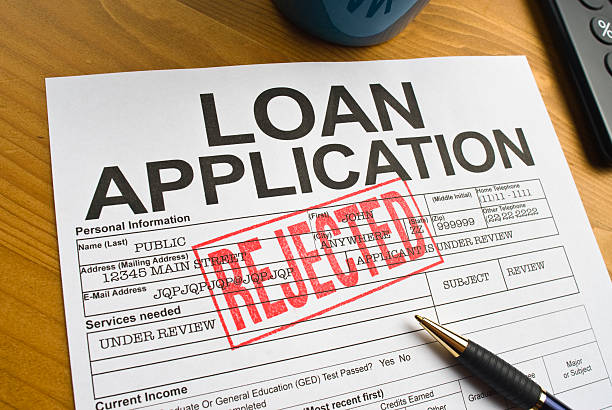 Rejected Loan Application Loan Application on a desktop stamped with a red "REJECTED". deteriorate stock pictures, royalty-free photos & images