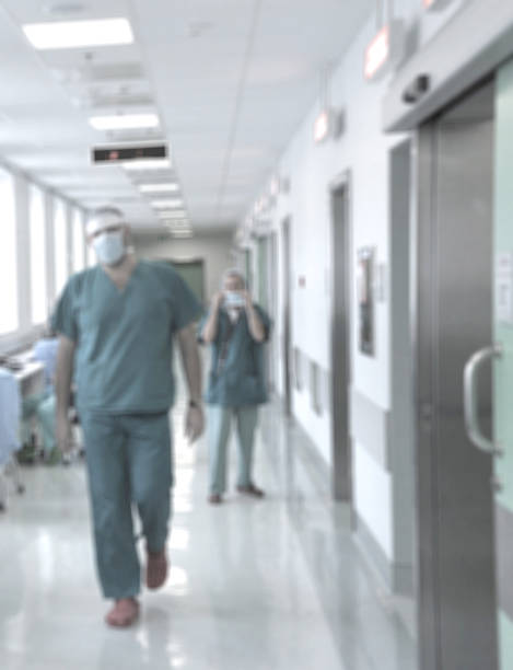istock Blurred motion doctors and nurses walking in hospital corridor 471222524