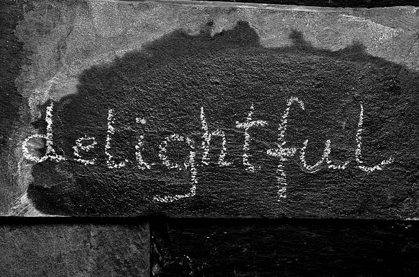 istock The word DELIGHTFUL written with chalk on black stone 471225388