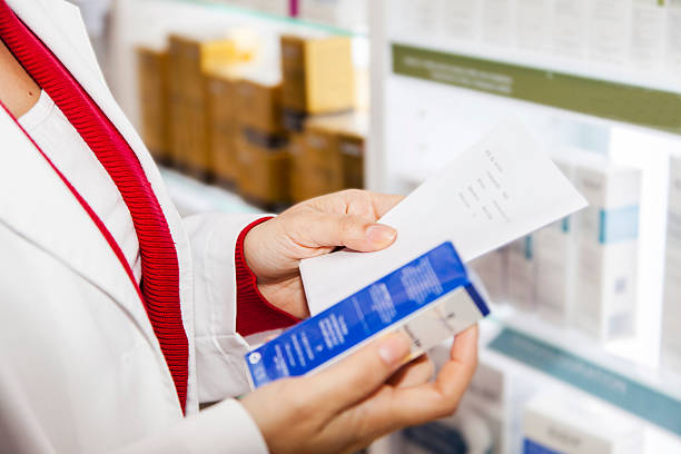istock Pharmacist reading doctor prescription 471227450