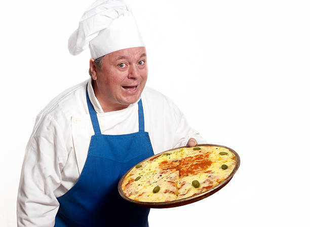 Portrait of happy attractive cook with pizza stock photo