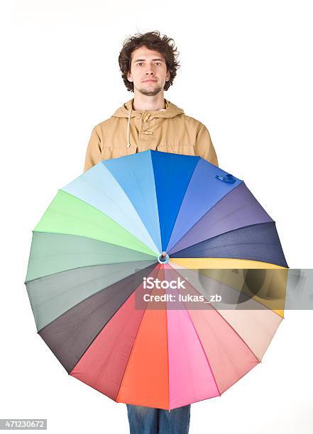 Handsome Man In Light Brown Vintage Raincoat Holding Colorful Umbrella Stock Photo - Download Image Now