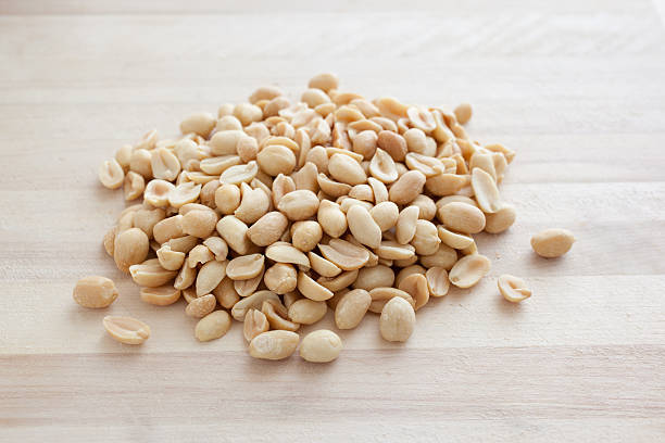 istock Pile of Peanuts on a Cutting Board 471231169
