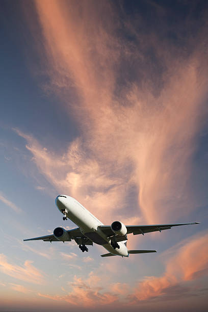 istock Jet Aeroplane Landing from Bright Twilight Sky Vertical 471231939