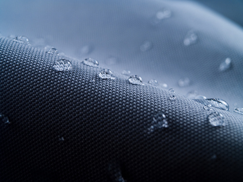 Macro shot of water rain drops on waterproof textile jacket. Extreme depth of field. Please visit my portfolio for different shots of this subject.