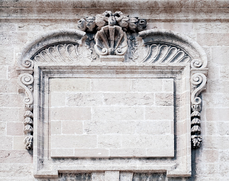 An intricately carved, empty stone frame on the wall of the Town Hall (Hotel de Ville, built 1656) in Marseilles, France.