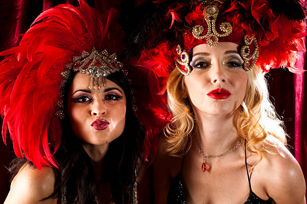 istock Two showgirls behind stage curtain getting ready for show. 471234363