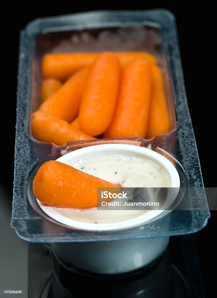 Baby carrots and ranch dressing dip Baby carrots and ranch dressing small plastic tray  (this picture has been taken with a Hasselblad H3D II 31 megapixels camera) Appetizer Stock Photo