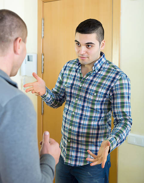istock angry men looking at each other with clenching fists 471235262