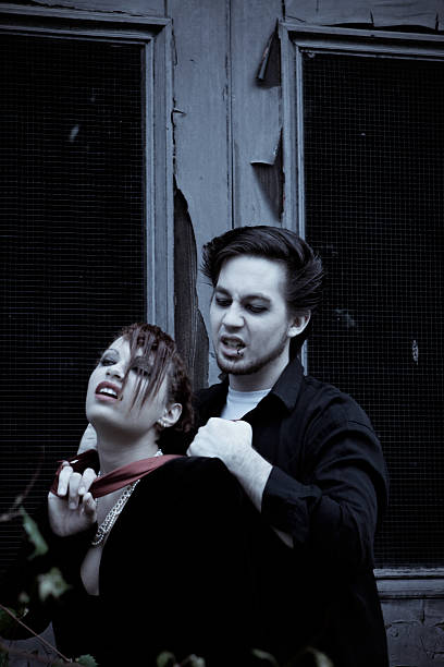 Young Man Choking a Woman At Night Young Man Choking a Woman At Night in front of an abandoned building woman strangles man stock pictures, royalty-free photos & images