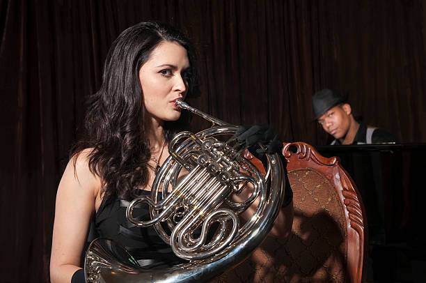 istock Woman Playing a French Horn 471235769