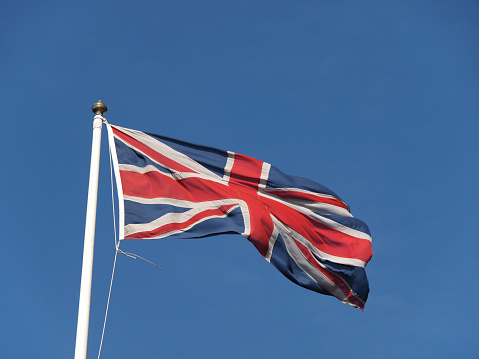 The Union Jack flying against a blue sky