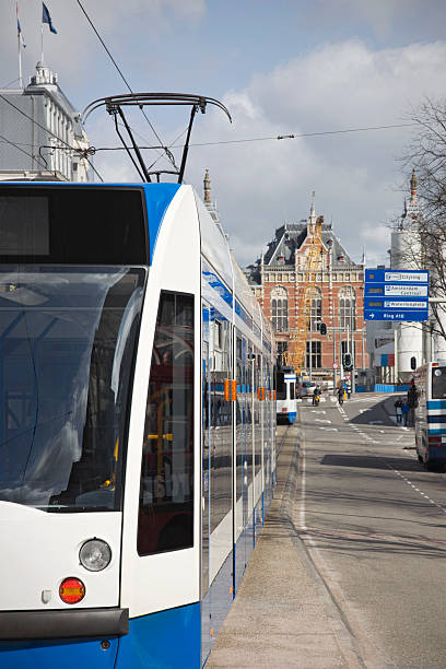 Close-up of a blue tram driving  downtown Amsterdam in the Damrak area. Shallow DOF, taken March 2010.