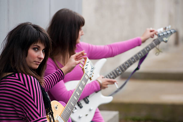 Young women with guitars.