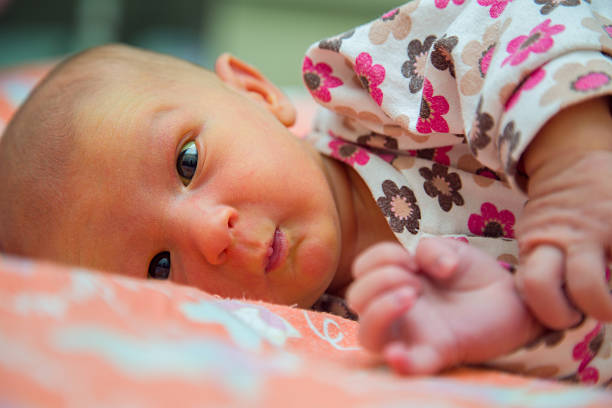 Surprised newborn baby looking stock photo