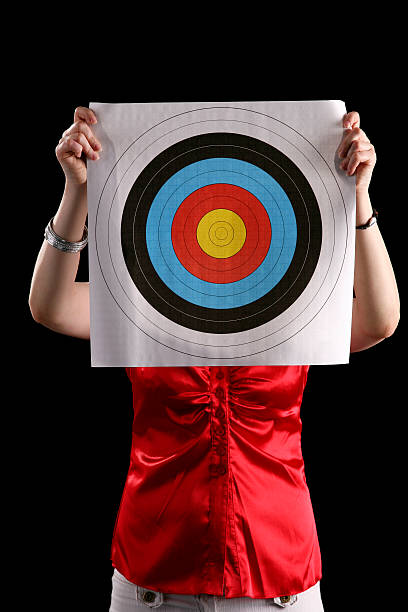 istock Woman holding a target 471239815