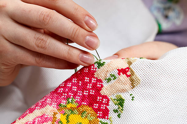 istock Cross stitching a colorful design 471240135