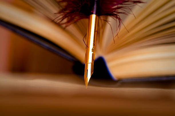 istock Old book and quill pen 471241479