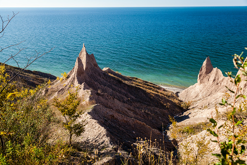 Chimney Bluffs State Park is located east of Sodus Bay, on the shore of Lake Ontario, in Upstate New York.  The Bluffs are knive-like spires formed by the erosion of clay-based glacial till.  Facing north west they receive the severe  erosive forces comming off the lake.