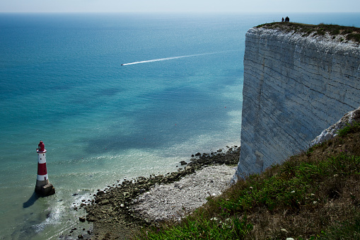 Famous Beachy Head lighthouse in comparison with huge white cliffs