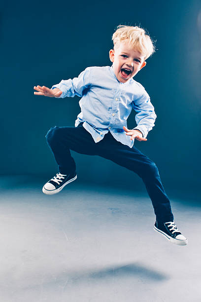 istock Boy is having fun and jumps high in the air 471243922
