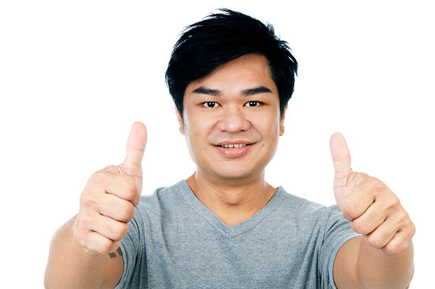 istock Cheerful young guy showing thumbs up sign 471244259
