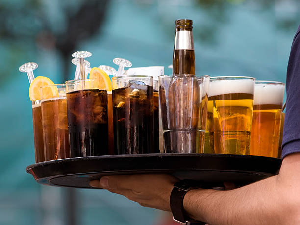 istock Server holding a tray of various types of drinks 471244699