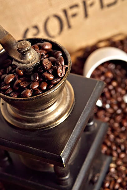 fresh coffee beans fresh coffee beans in an old coffeemill aromatisch stock pictures, royalty-free photos & images