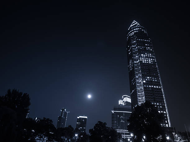 Trade Fair Tower, Messeturm, and full moon in the exhibition site of Frankfurt, Germany