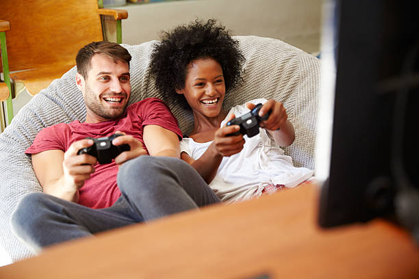 istock Young Couple In Pajamas Playing Video Game Together 471246880