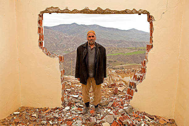 mature man standing - earthquake turkey stockfoto's en -beelden