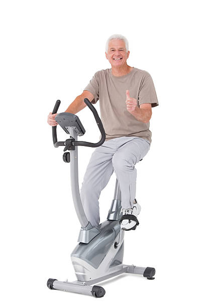 istock Senior man on exercise bike 471247192