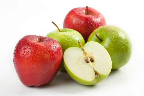 Red apples with green leaf and half slice on wooden table background. Top view. Flat lay.