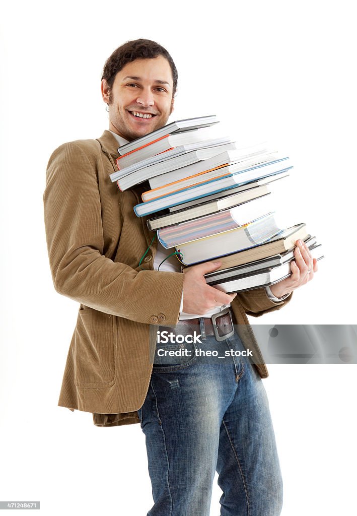 Estudiante con una pila de libros - Foto de stock de 20 a 29 años libre de derechos