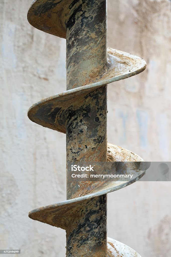 Heavy duty drill bit an industrial drill bit, one used to drill deep ground wells, macro.  This is about a 6" diameter drill bit. Backgrounds Stock Photo