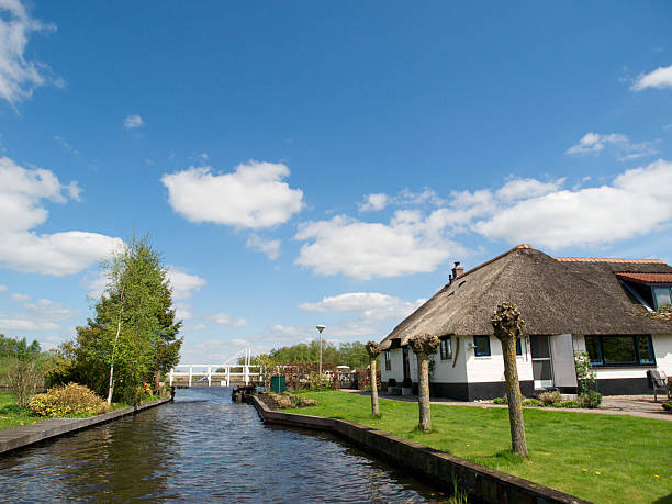 Beautiful traditional house with a thatched roof on a small island near Giethoorn en the Weerribben. Giethoorn is sometimes called \