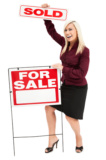 Photo of a real estate agent isolated against white, standing next to a \