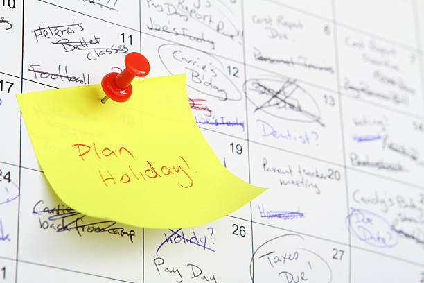 Reminder to take a break and plan a holiday Busy calendar with "Plan a Holiday" on a memo busy calendar stock pictures, royalty-free photos & images