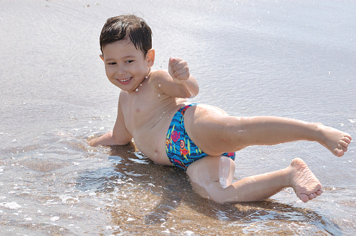 Little Boy Playing on Beach