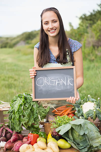 istock Pretty brunette selling organic vegetables 471254714