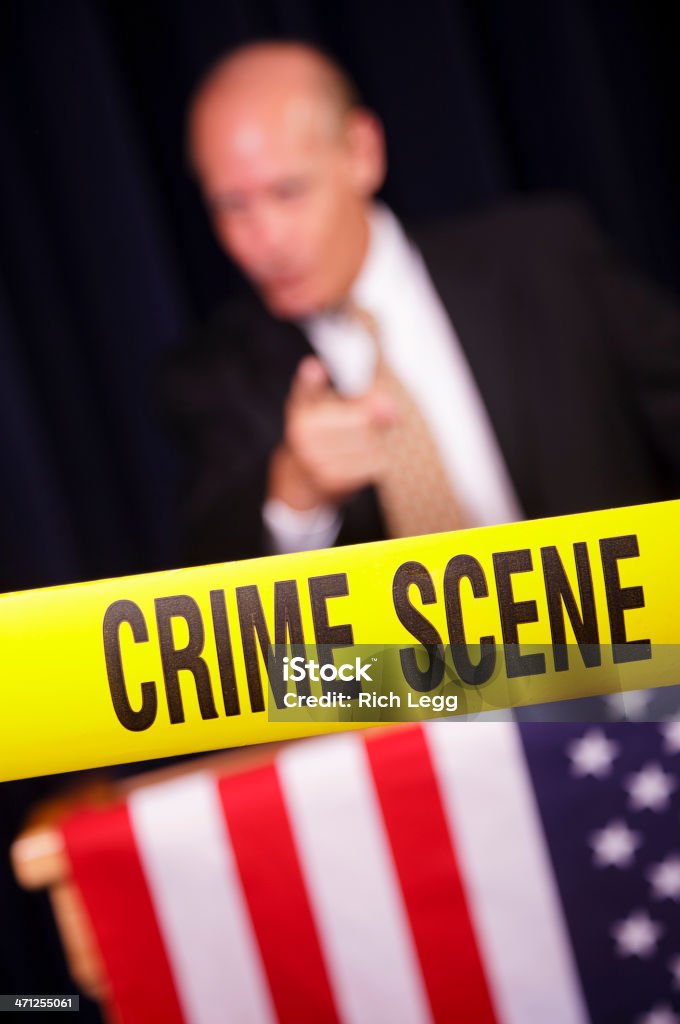 Crooked Poitician A politician talking from a podium behind yellow "Crime Scene" tape. 50-59 Years Stock Photo