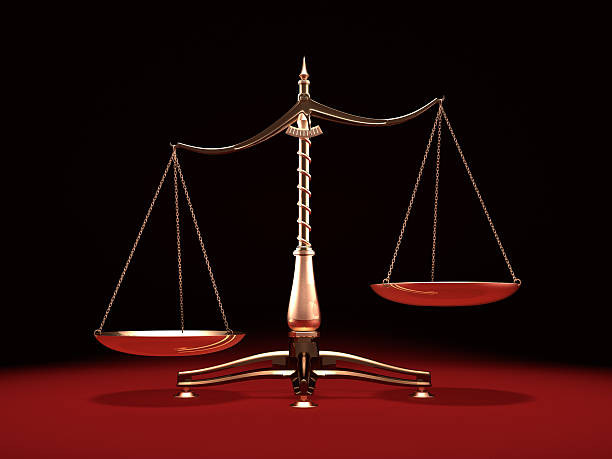 Brass Weight Scales Biased brass weight scales Law and Justice symbol Isolated on black red background unbalance stock pictures, royalty-free photos & images